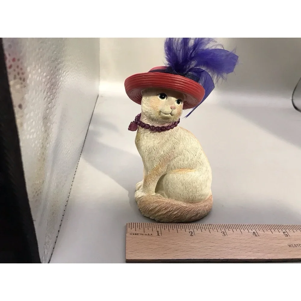 Pretty White Resin Kitty With A Red Hat With Purple Feather